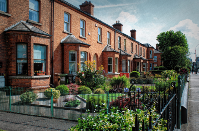 A row of red-brick houses along a road