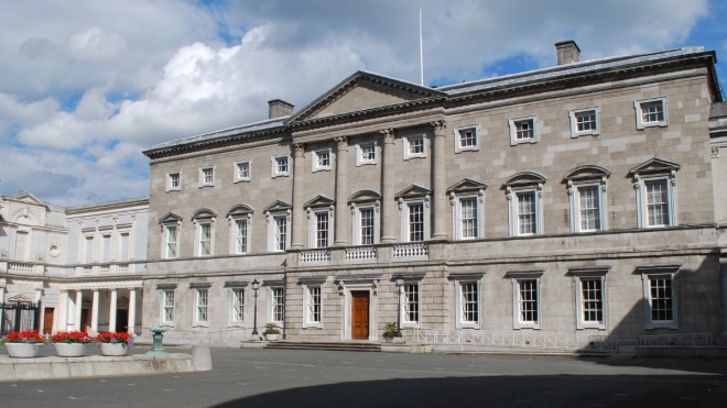 Large grey building with three storeys and lots of windows